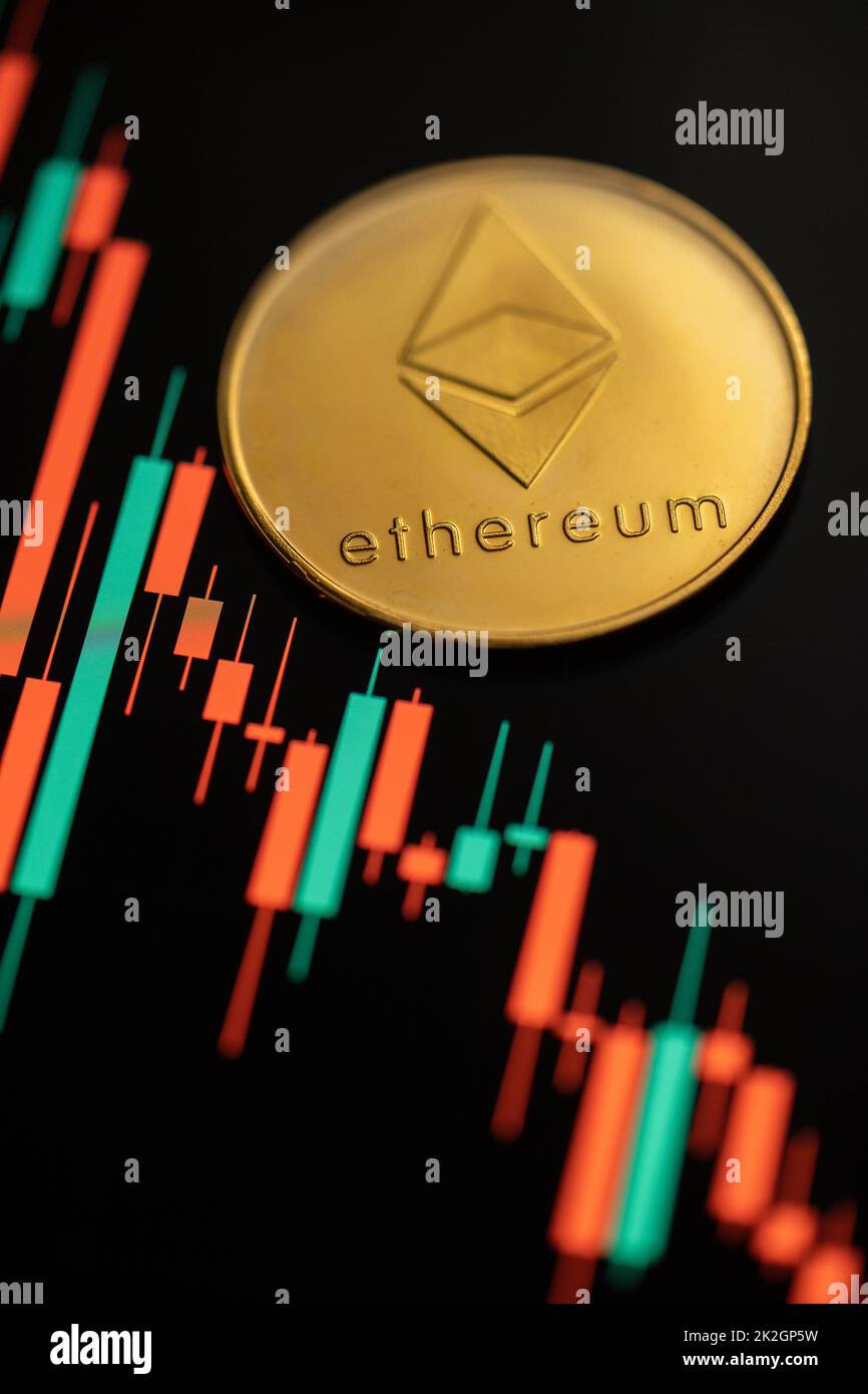 Gold Ethereum cryptocurrency with candle stick graph chart and digital background. Stock Photo