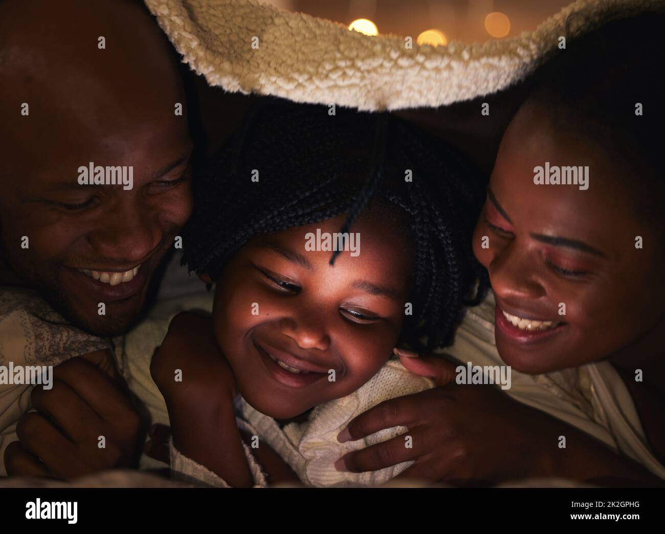 The tiniest moment can create the biggest memory. Shot of a young family bonding at home. Stock Photo