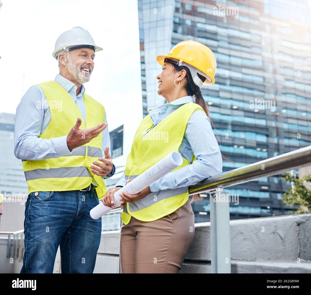 Its going to be great when were done. Shot of two businesspeople working together at a construction site. Stock Photo