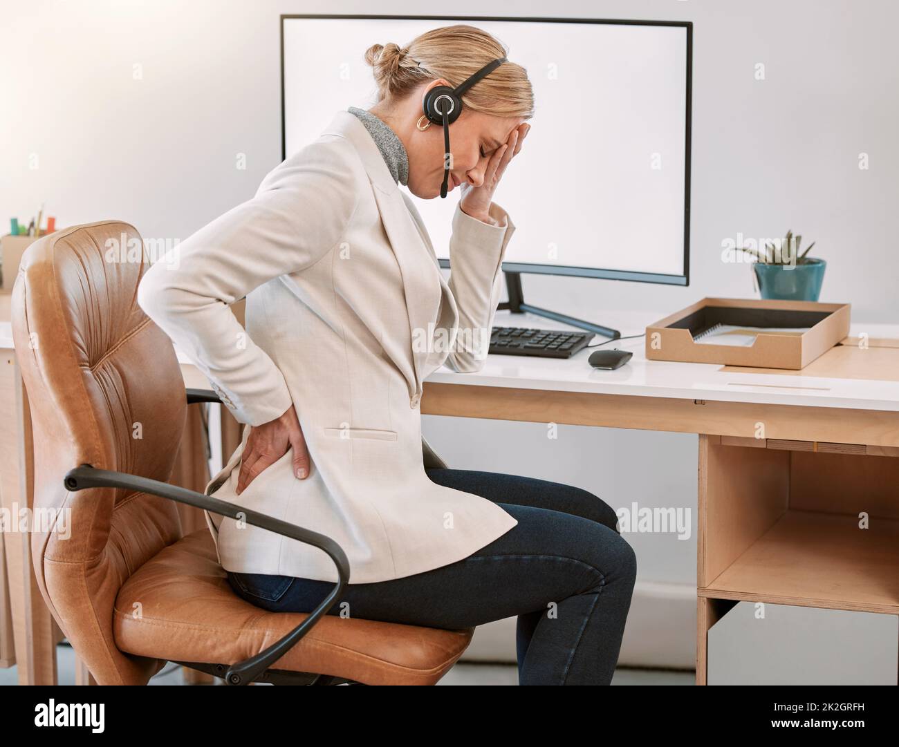 My back is killing me. Cropped shot of an attractive mature female call