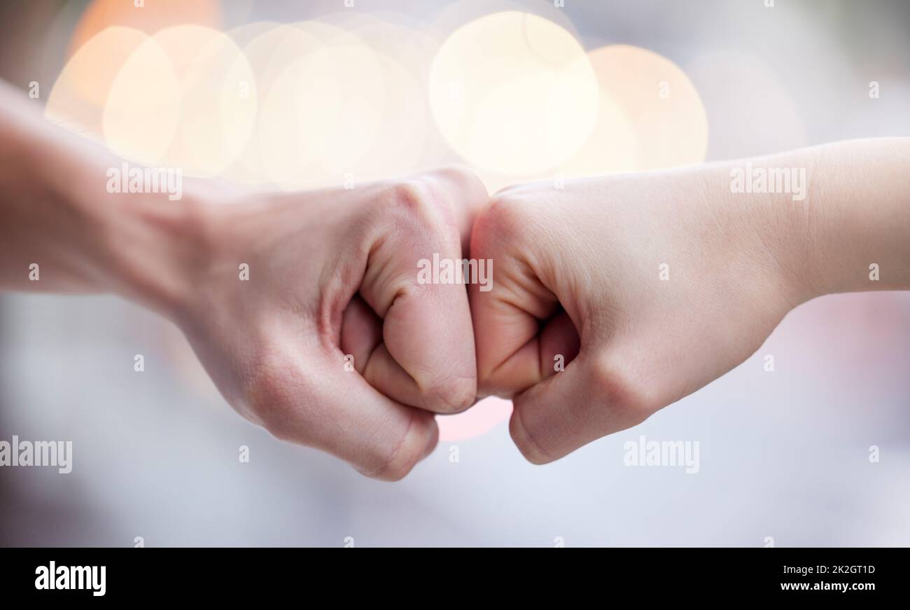 Weve got this. Shot of two unrecognizable people fist bumping. Stock Photo