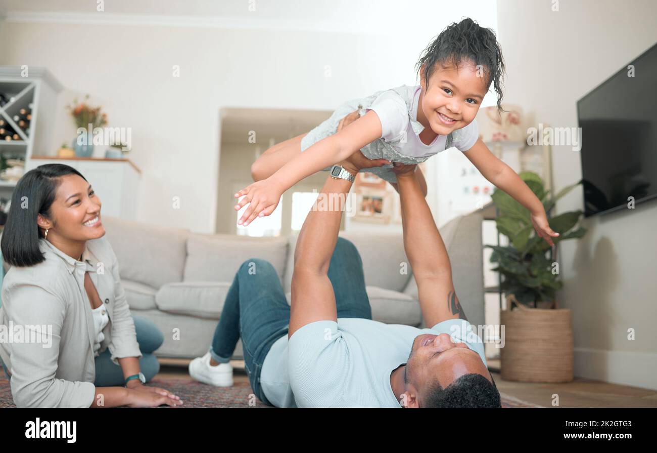 Higher Dad, higher. Shot of an adorable little girl bonding with her
