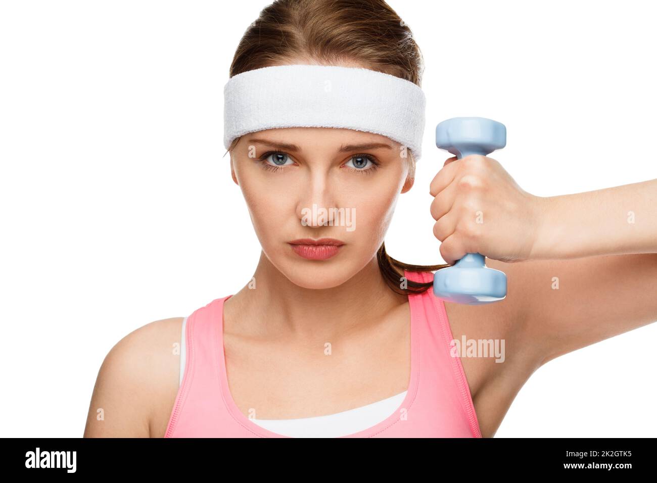 Ready to pump some iron. Shot of a young woman using weights against a