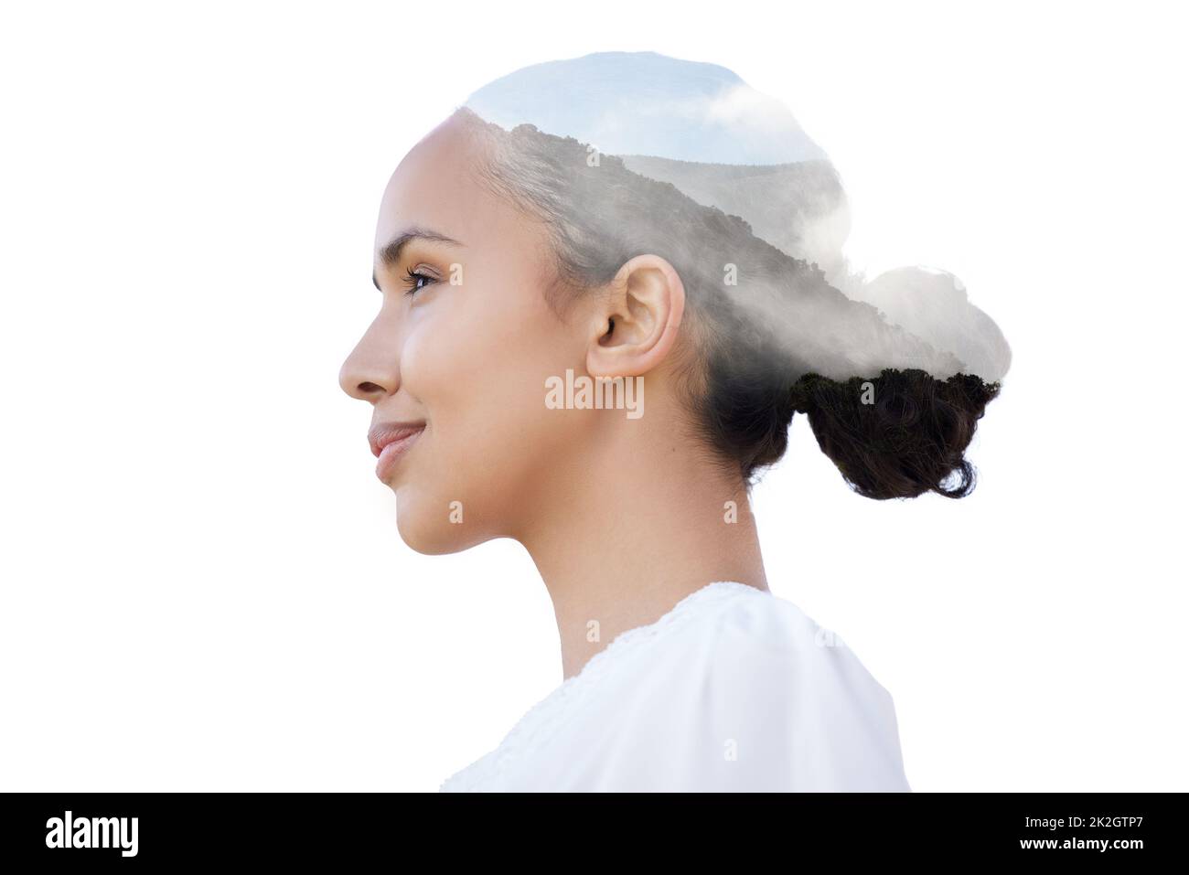 We can learn a lot about beauty from nature. Shot of a beautiful young woman with a mountain superimposed over her face against a white background. Stock Photo