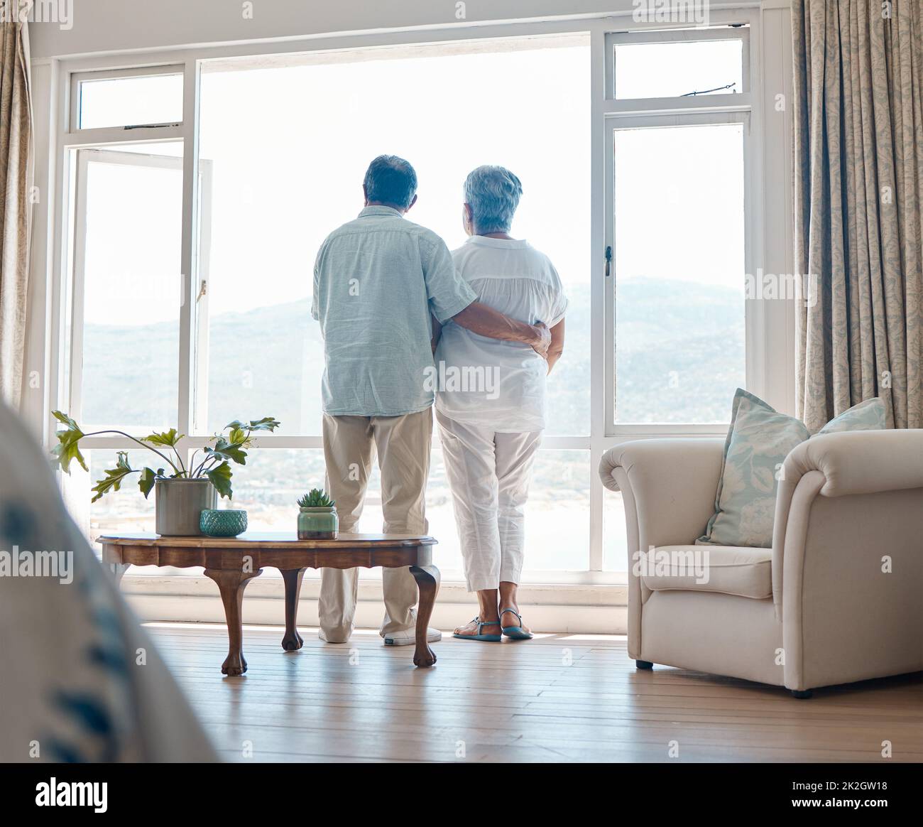 Enjoying some downtime. Rearview angle shot of a senior couple relaxing spending time together at home. Stock Photo