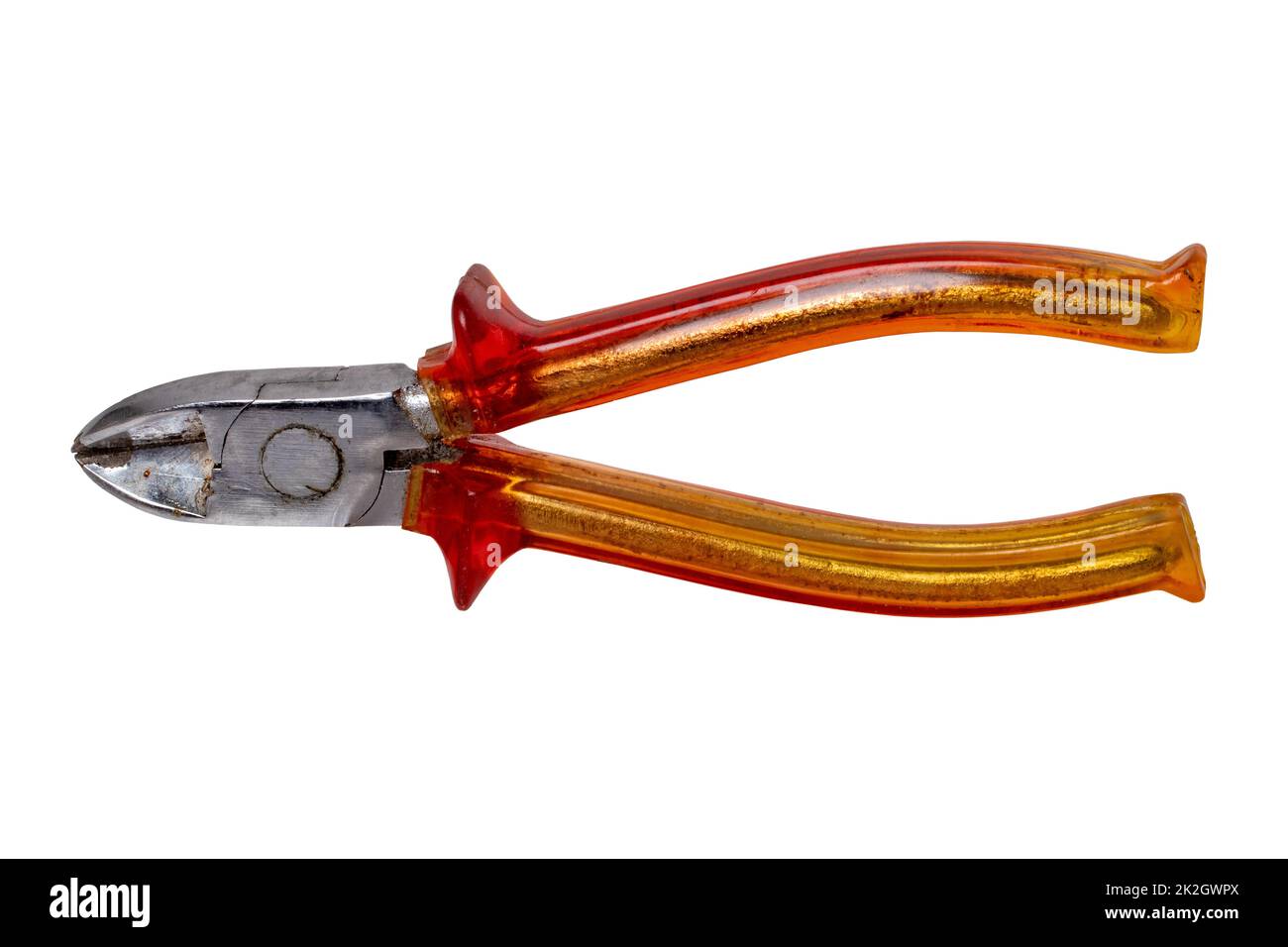 Closeup of an old rusty pair of cutting pliers or side cutters for cutting wire with red plastic handles isolated on white background. Clipping path. Electrician's tool. Stock Photo