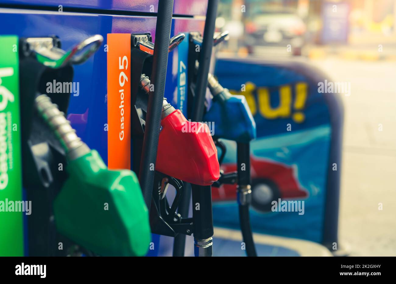 Petrol pump filling fuel nozzle in gas station. Fuel dispenser. Refuel fill up with petrol gasoline. Gas pump handle. Red petrol fuel nozzle. Petroleum oil industry. Oil crisis. Petrol price crisis. Stock Photo