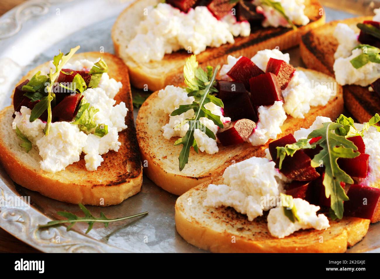 Bruschetta with beet, feta and ruccola Stock Photo - Alamy