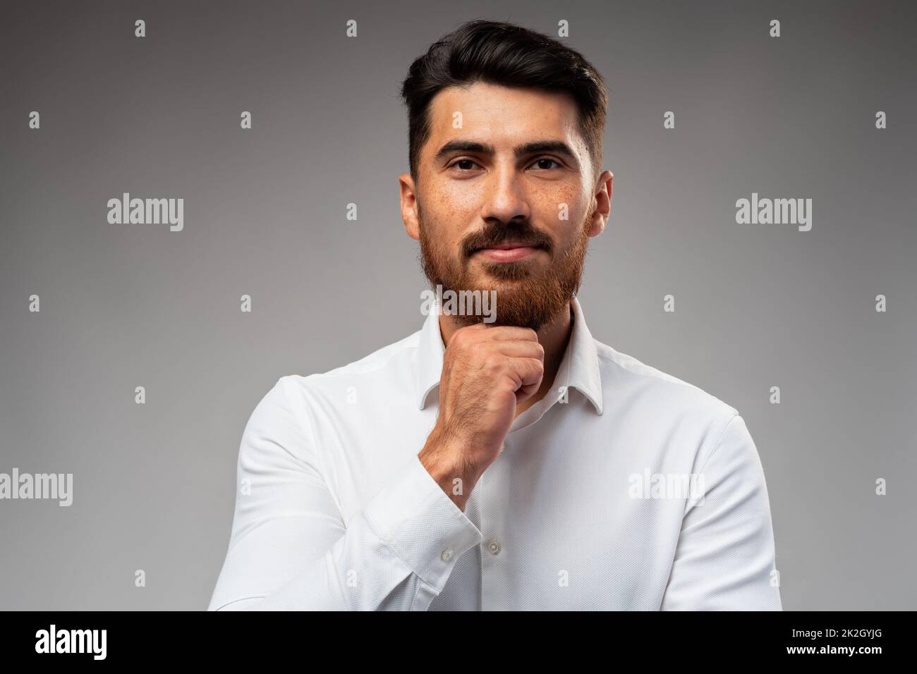 Studuo shot of thinking businessman standing over gray background Stock Photo