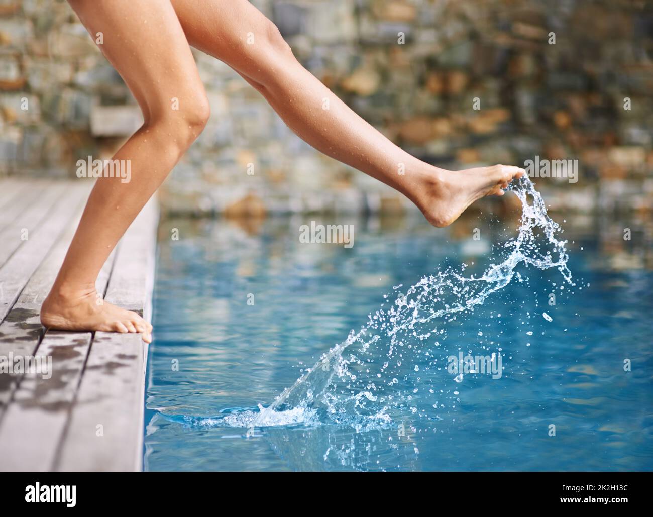 Getting a feel for the water. a womans foot in the swimming pool Stock Photo Alamy