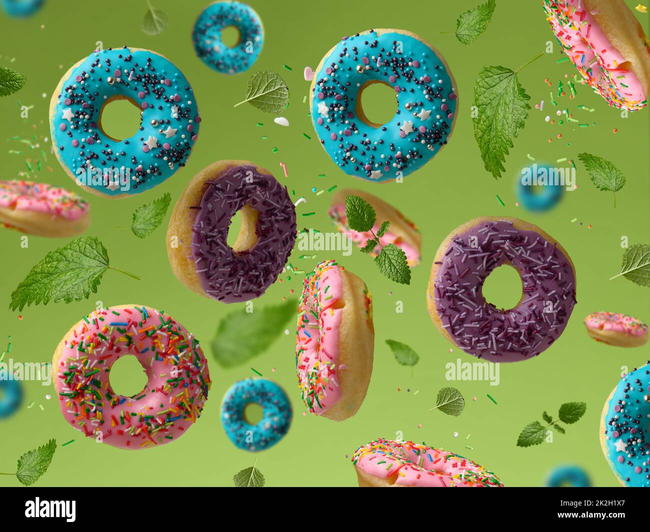 sweet multicolored donuts levitate on a green background, sugar ...