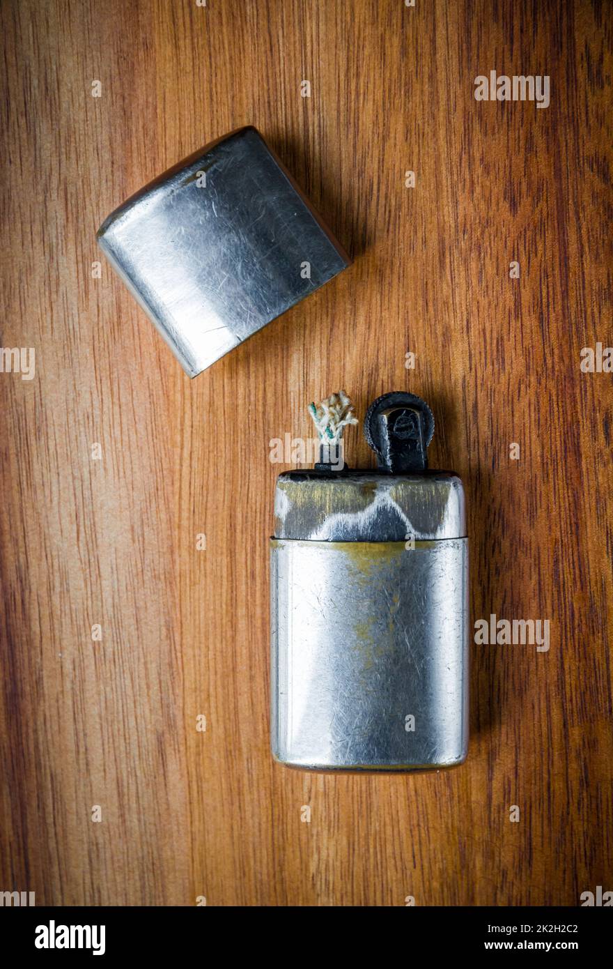 Old vintage lighter on a wooden background Stock Photo