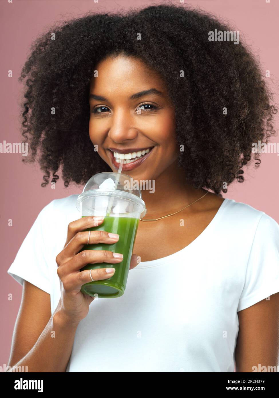 All my vitamins in one drink. Studio shot of an attractive young woman