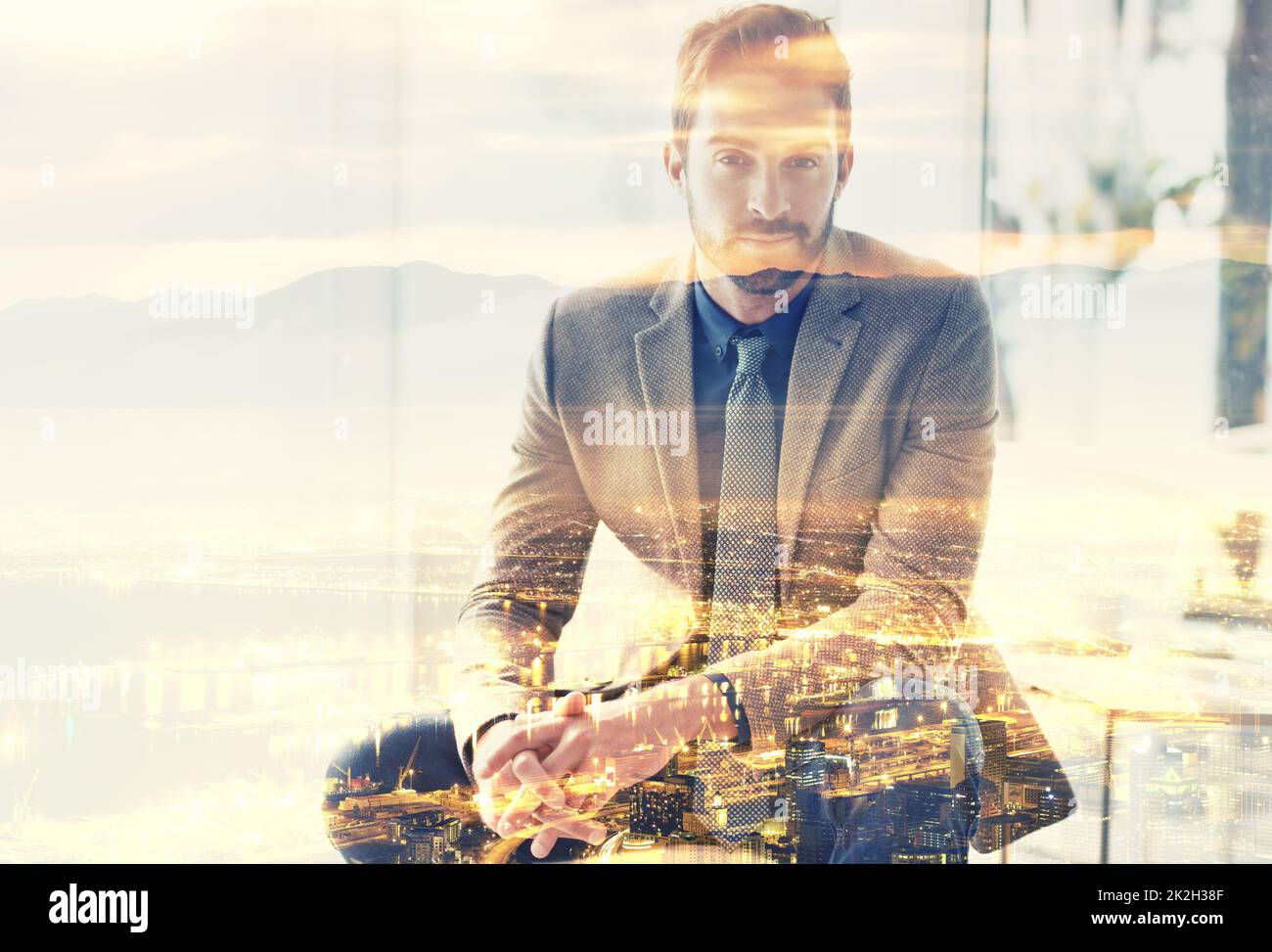 Life in the city. Composite image of a well-dressed man superimposed on an image of a city at night. Stock Photo