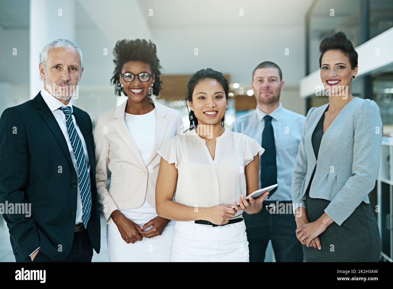 Theyre led by a confident, charismatic leader. Portrait of a group of businesspeople standing together. Stock Photo