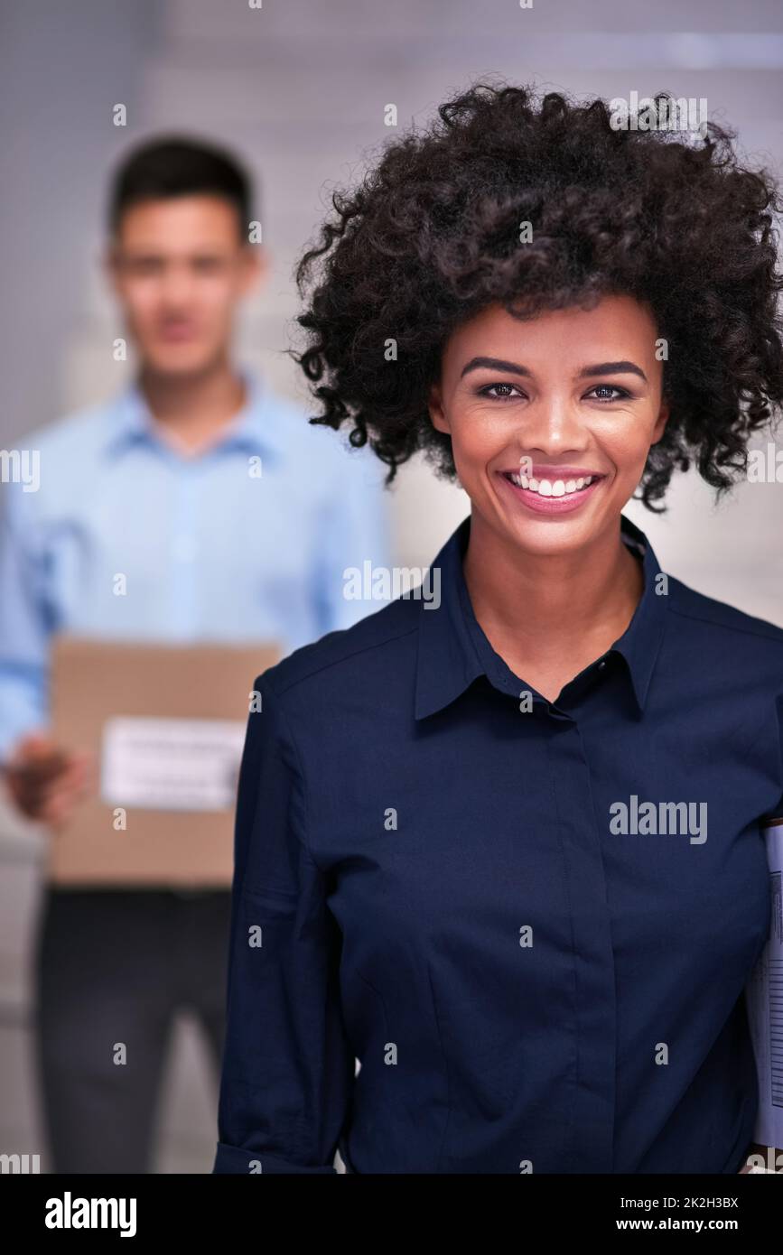 Logistics are our business. Portrait of a happy delivery woman making a delivery to a businessman in his office. Stock Photo