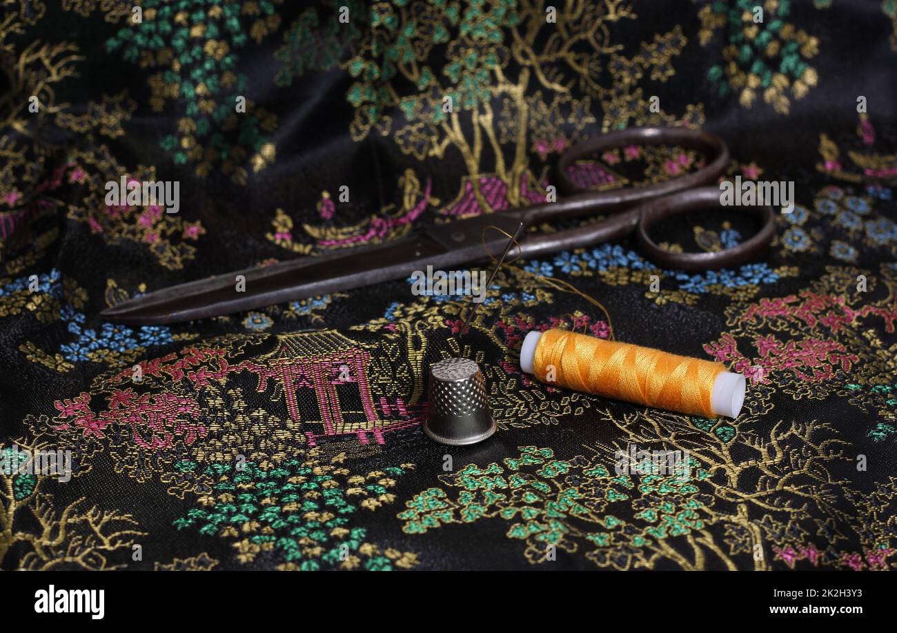 Yellow Thread and Thimble on Vintage Chinese Black Silk Stock Photo Alamy