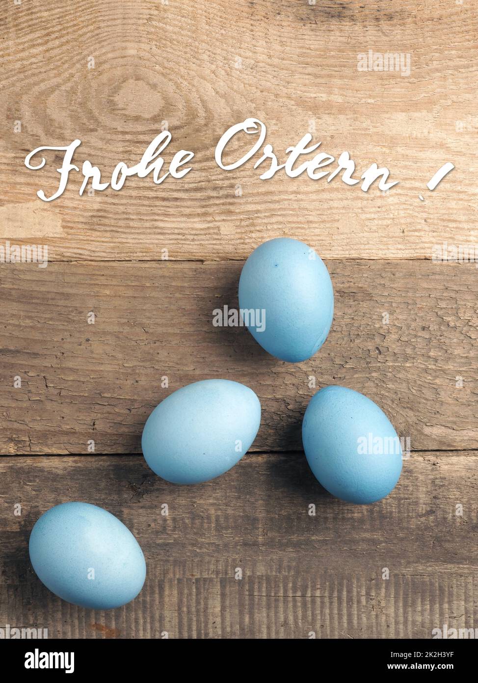 German Happy Easter with naturally blue colored organic eggs Stock Photo