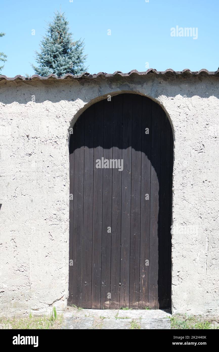 Wooden door in the wall Stock Photo
