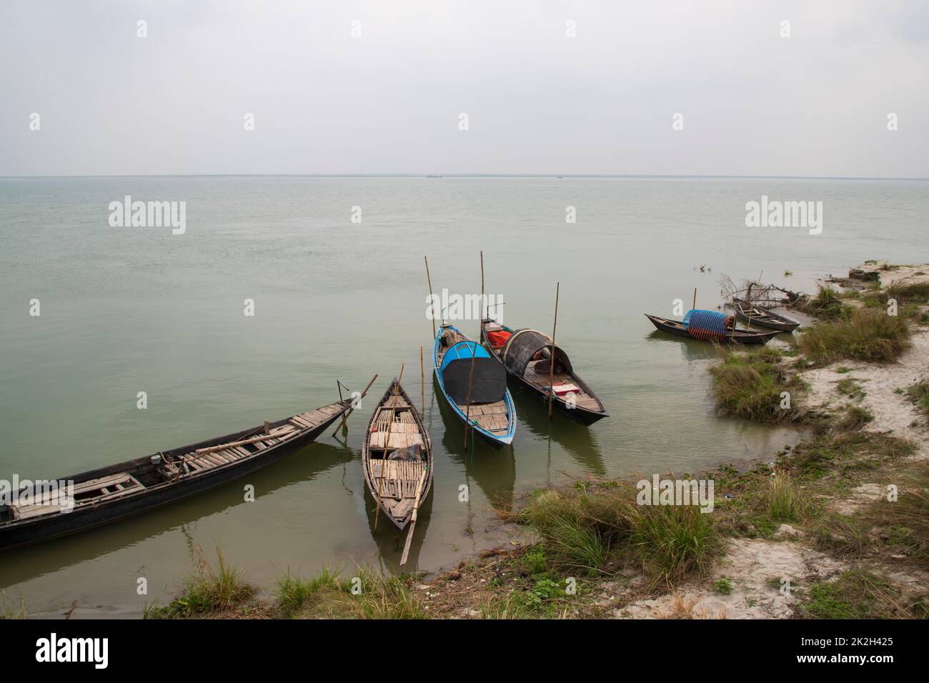 Some wooden fishing boats on the bank of the Padma river Stock Photo ...