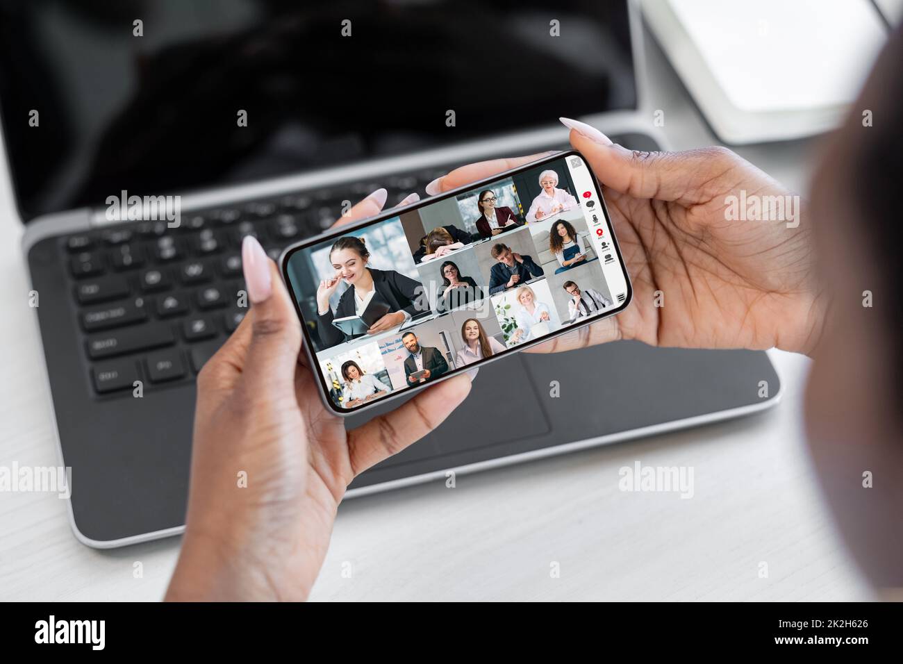 Business teleconference. Mobile video call. Virtual interview. Communication technology. Woman cooperating online with team on smartphone screen. Stock Photo