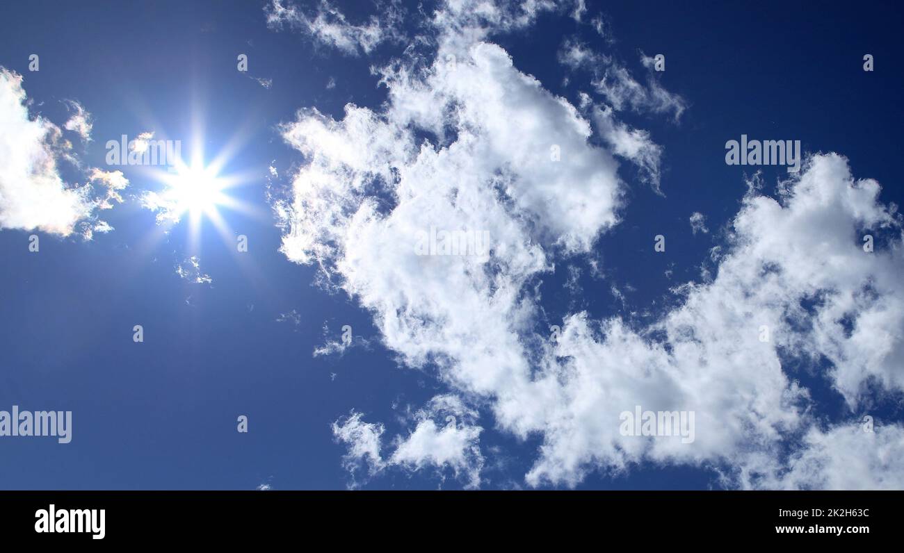 Bright sunshine, white clouds and blue sky Stock Photo