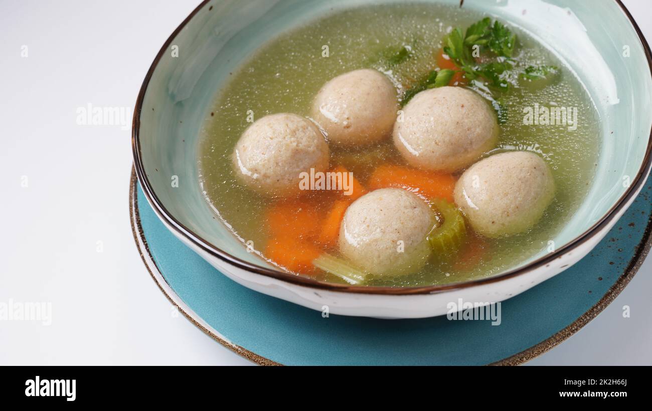 Jewish chicken broth with kneidlach (balls made with matzo meal)Matzo ball soup Stock Photo