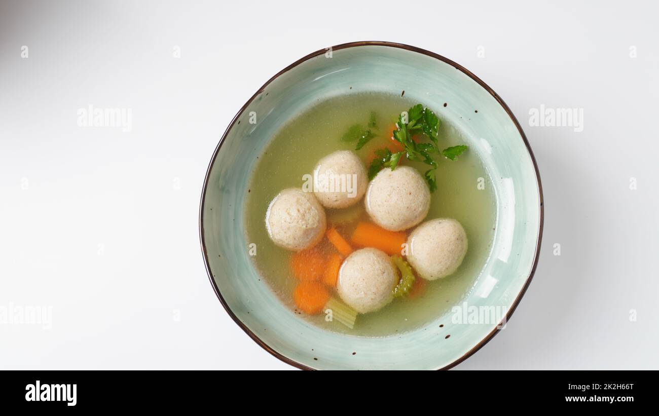 Jewish chicken broth with kneidlach (balls made with matzo meal)Matzo ball soup Stock Photo