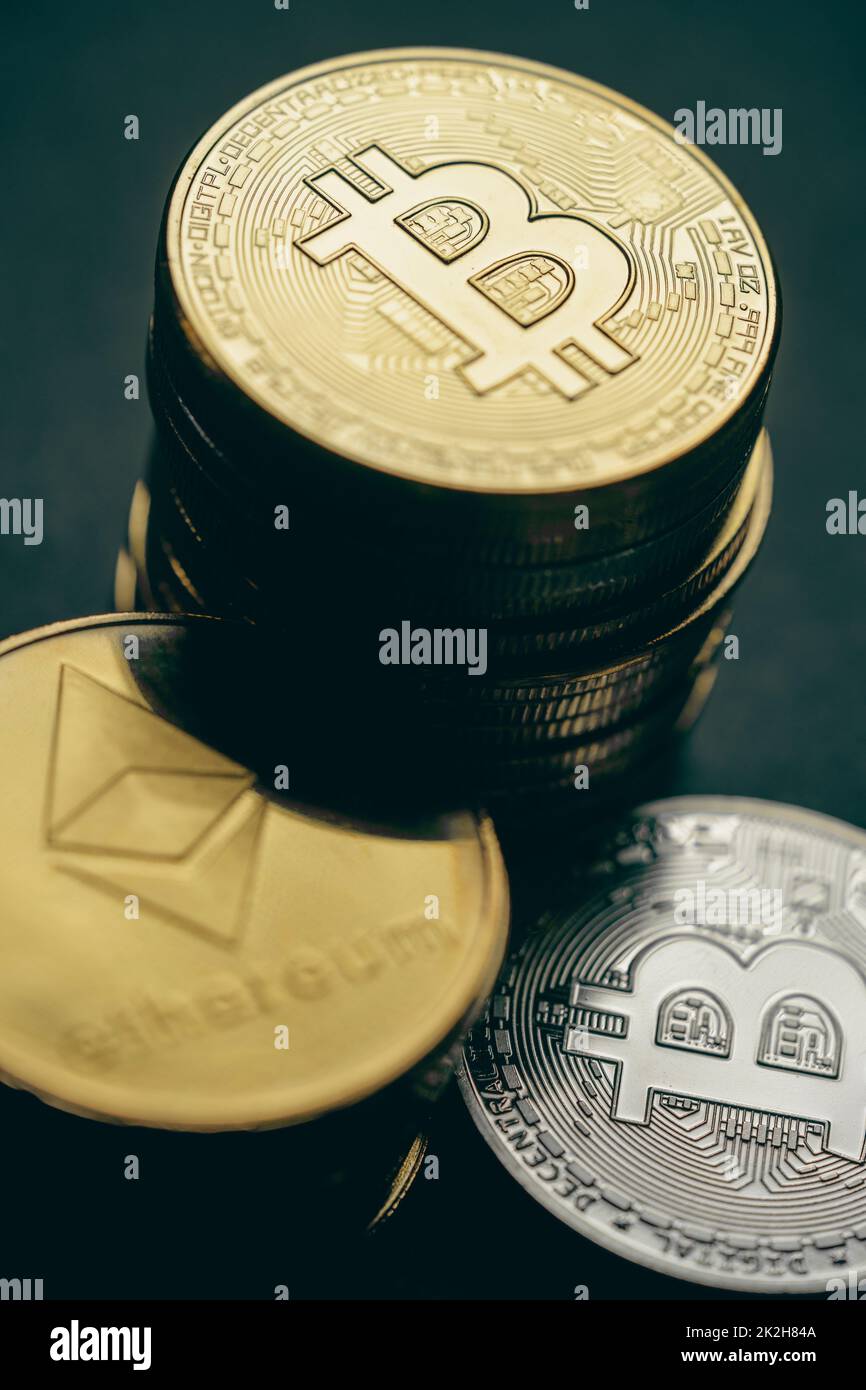 Close up shot of stacks of golden Bitcoin and Ethereum digital cryptocurrency coins. Stock Photo