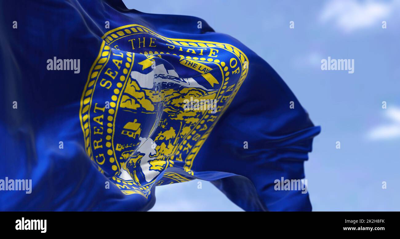 The US state flag of Nebraska waving in the wind. Stock Photo