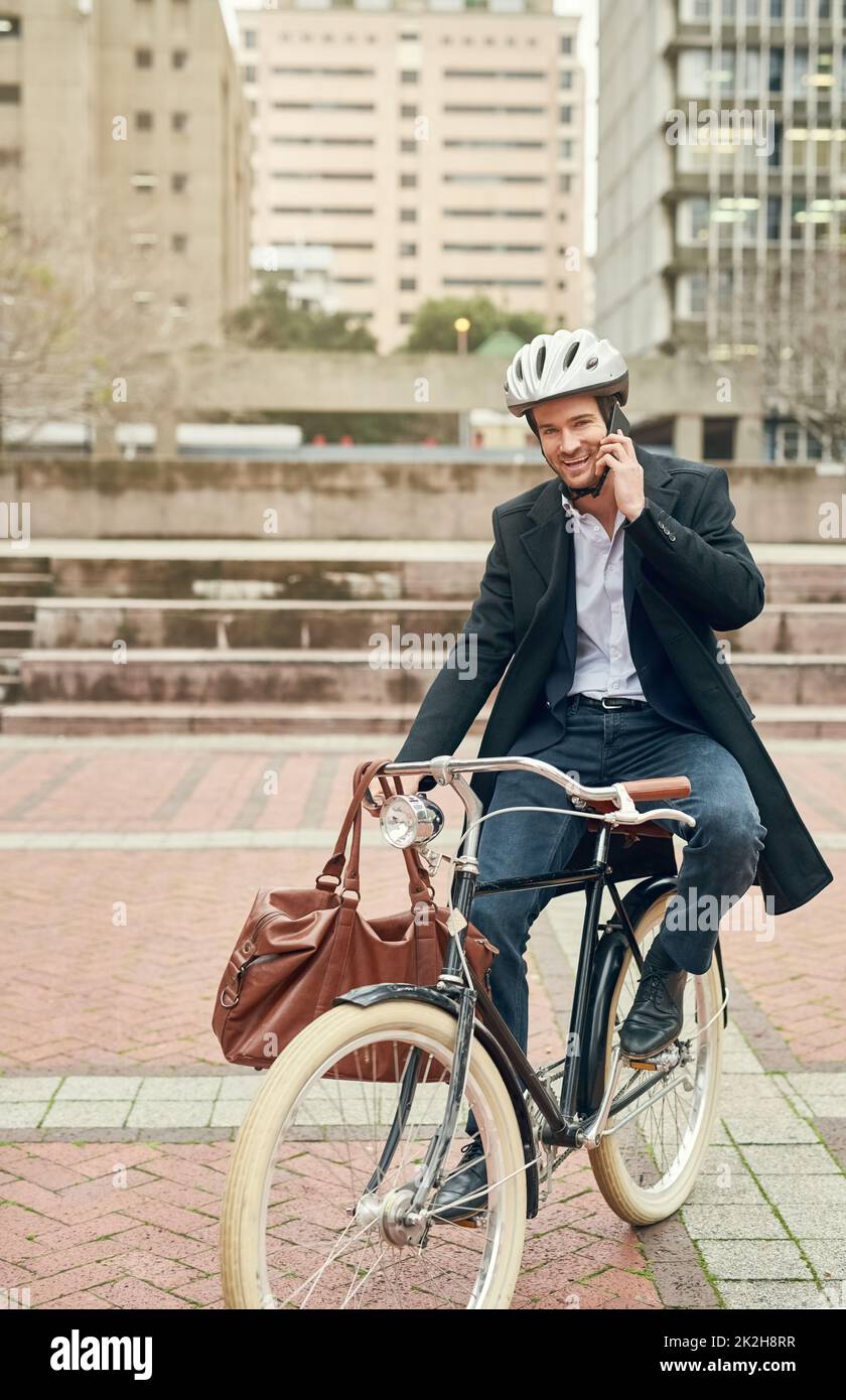 The world could do with more green. Portrait of a young businessman commuting to work with his bicycle. Stock Photo