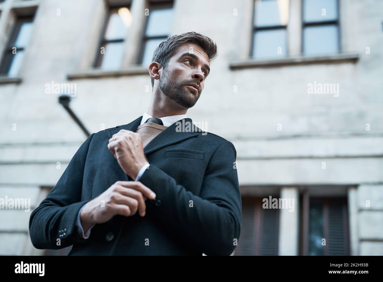 Dressed for success. Low angle shot of a handsome businessman about town. Stock Photo