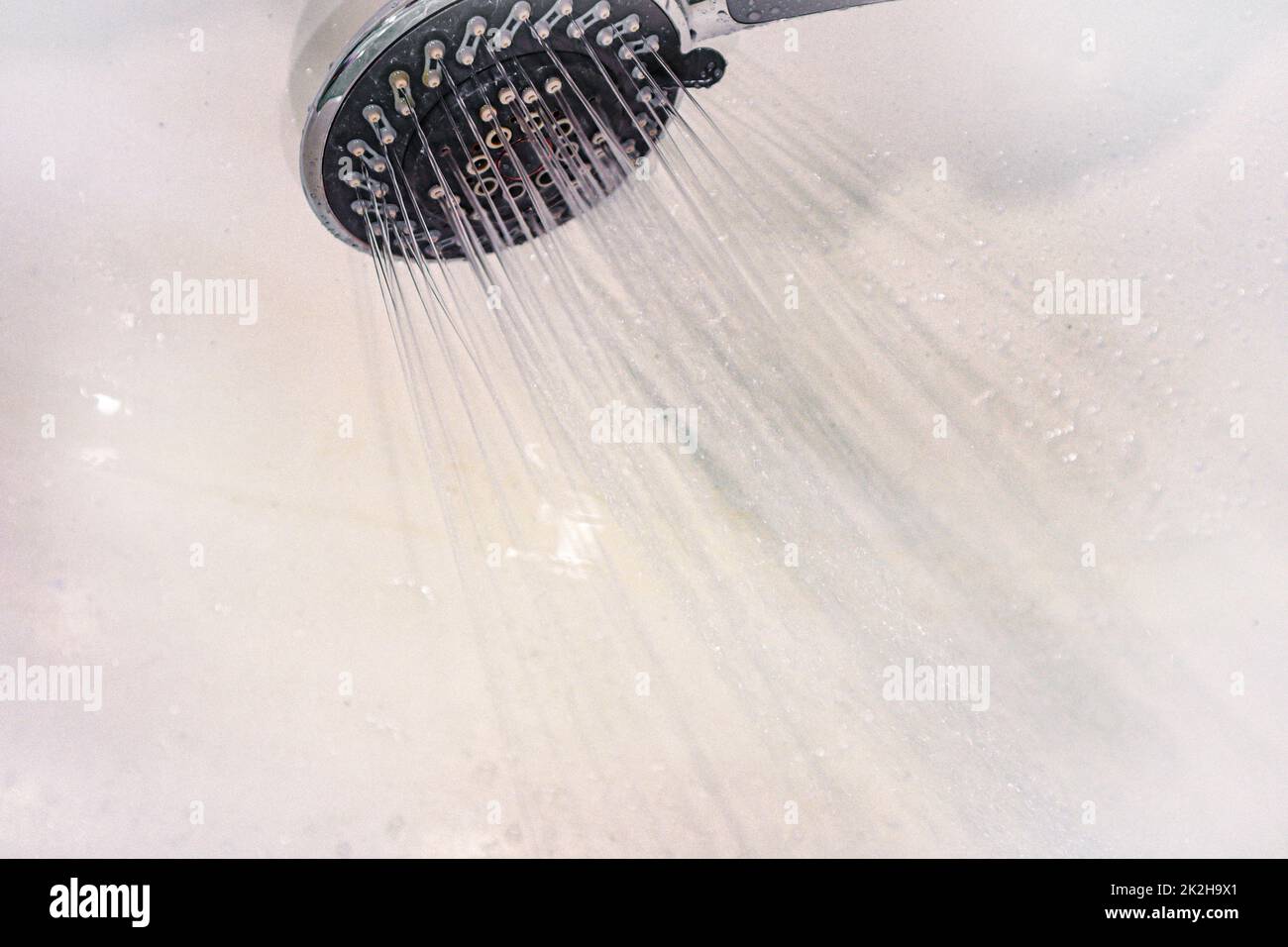 Drops of water fall from the watering can in the shower closeup. The