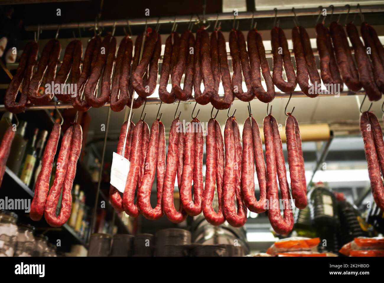 Butchers market. dried sausages hanging on hooks at a market stall