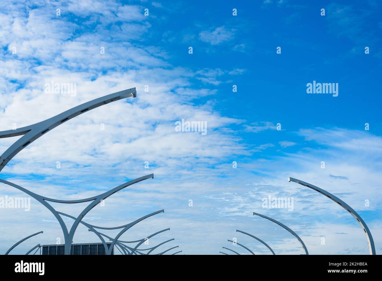 Design street lights standing on toll road against blue sky Stock Photo