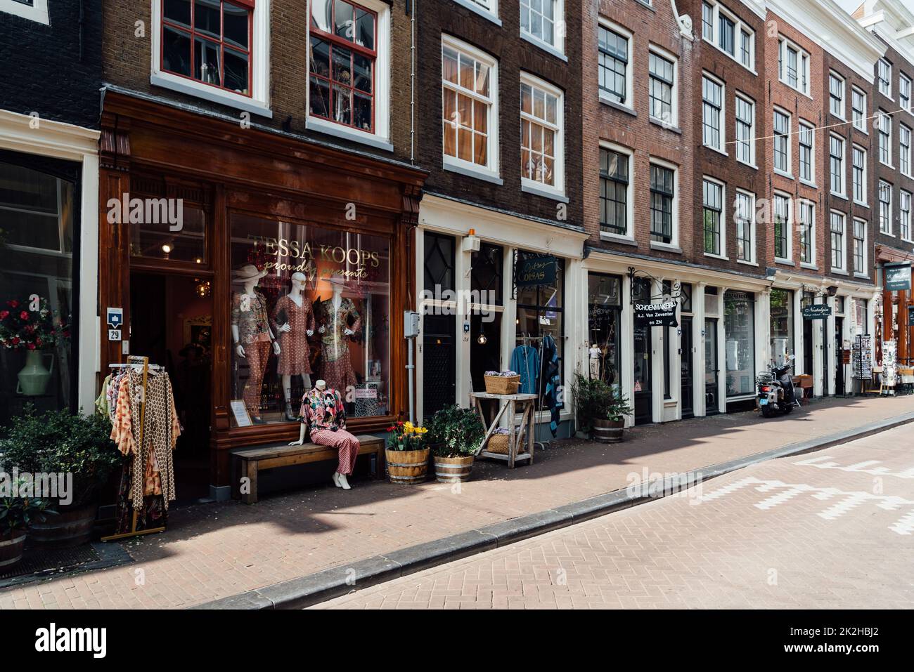 Amsterdam, Netherlands - May 7, 2022: Cozy shopping street with fashion stores Stock Photo