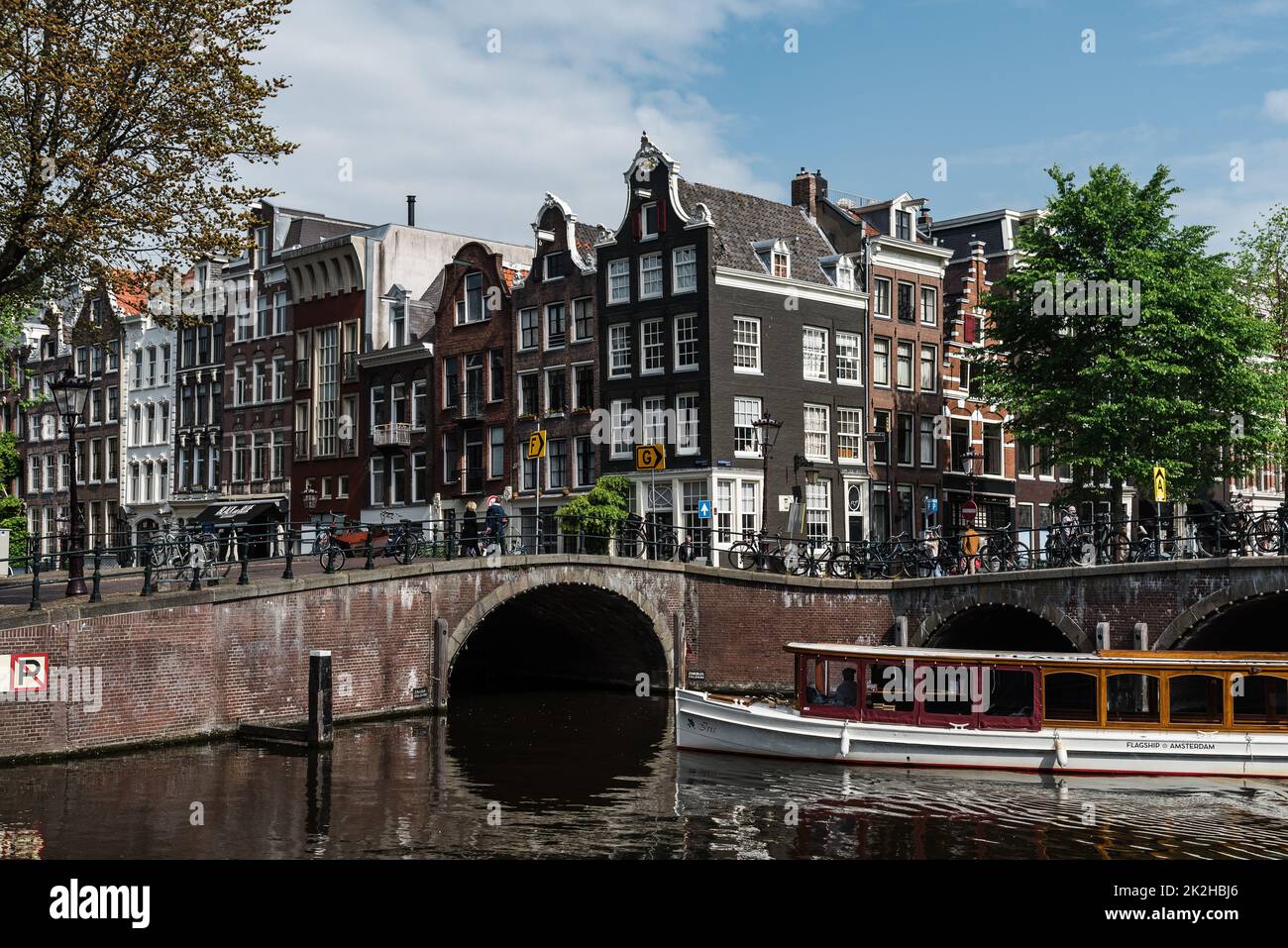 Amsterdam, Netherlands - May 7, 2022: Scenic view of canal with typical Dutch houses in early morning Stock Photo