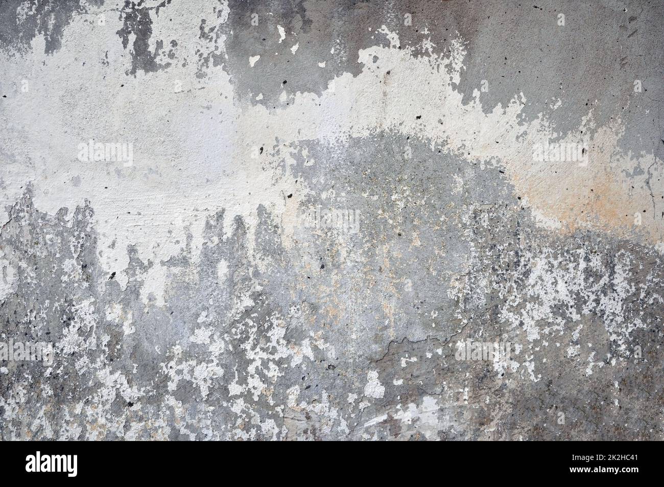 Empty old plastered wall texture. Painted problematic wall surface. Dilapidated building facade with damaged plaster. Stock Photo