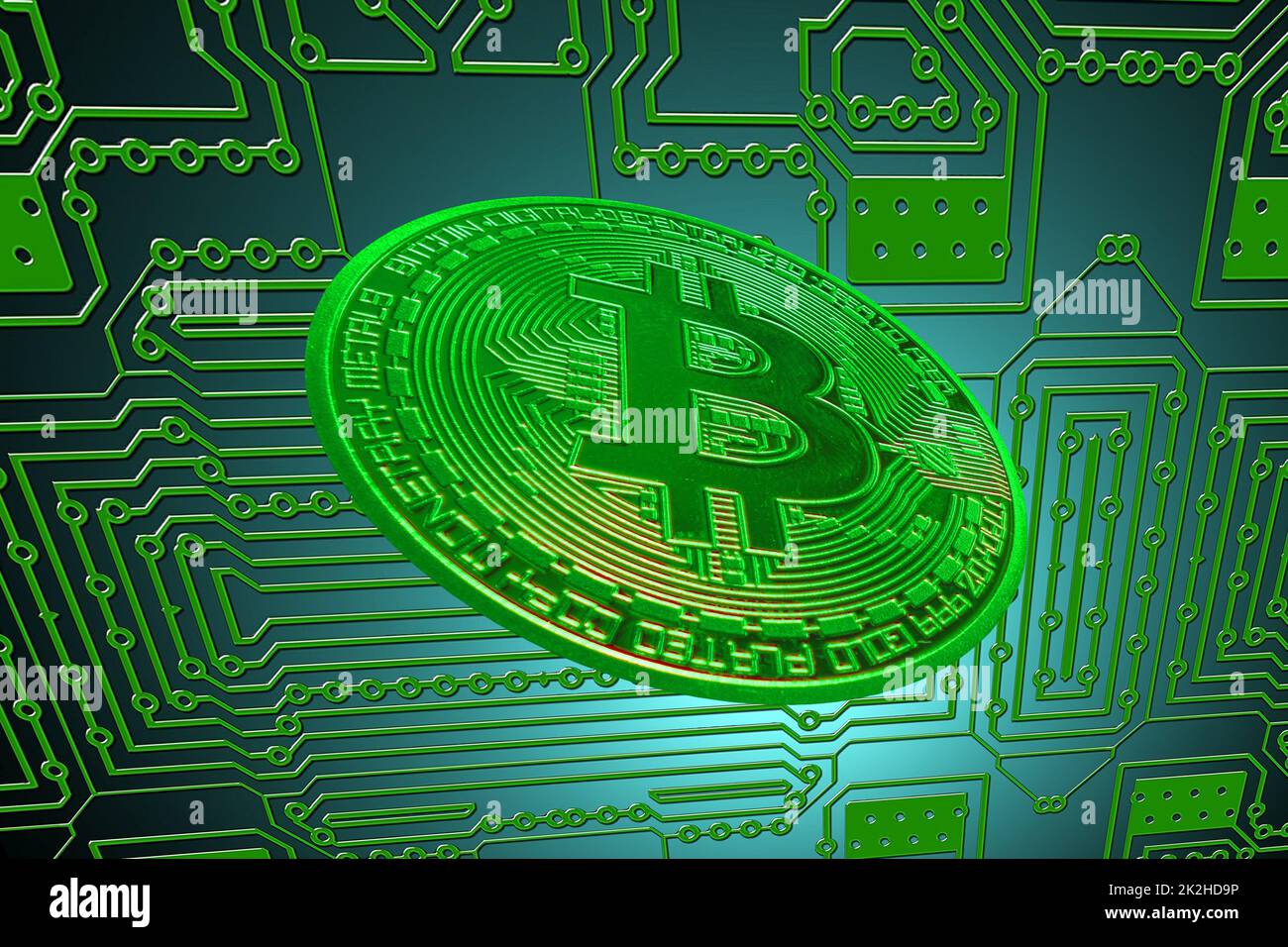 green circuit board and a valueable green bitcoin from crypto currency oblique Stock Photo