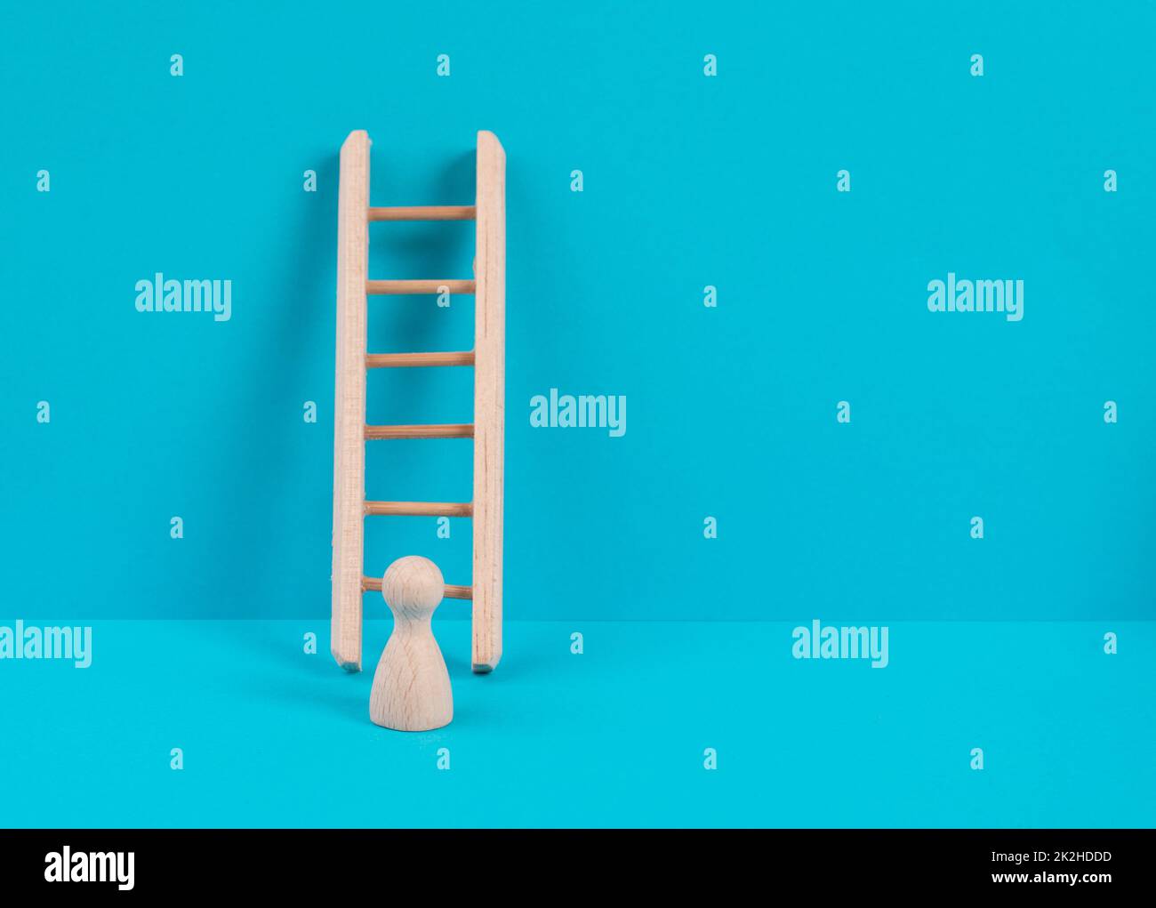 Man is standing next to a ladder, climbing up in career, having a goal, brainstorming for ideas, success strategy, taking a challenge, business concept Stock Photo