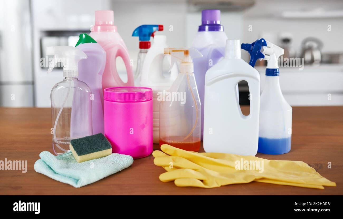 The spring cleaning starter pack. Shot of various cleaning products on a table in the kitchen at home. Stock Photo