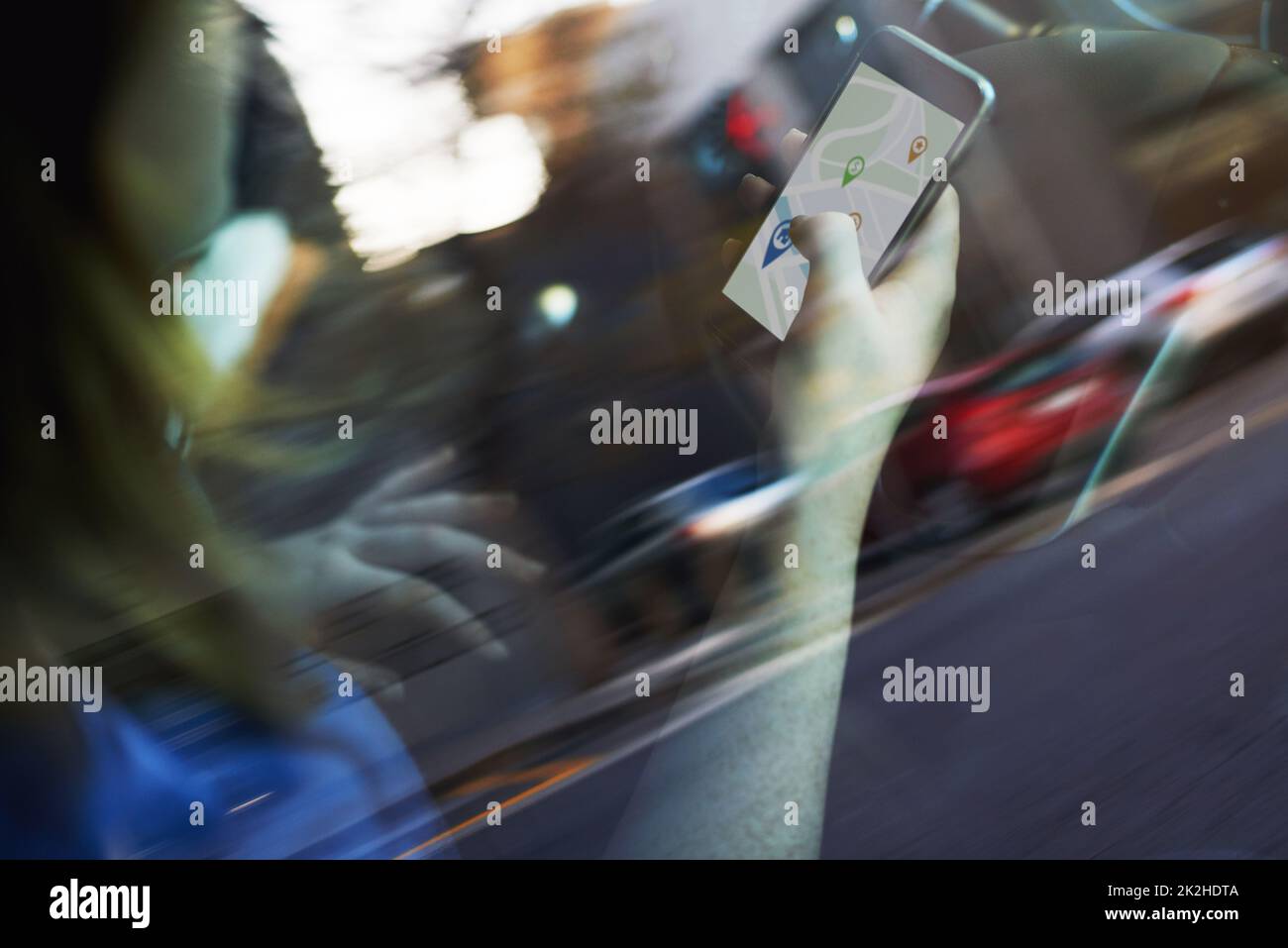 Looking for directions Theres an app for that. Cropped shot of a woman using her phones gps while driving. Stock Photo