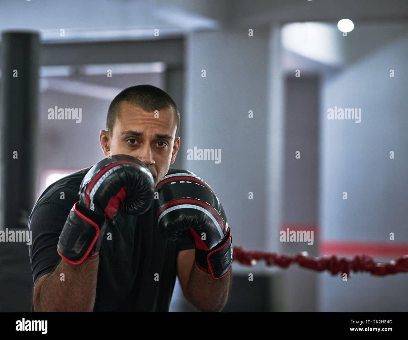 Working on his form. Cropped portrait of a young male athlete training inside a boxing ring. Stock Photo