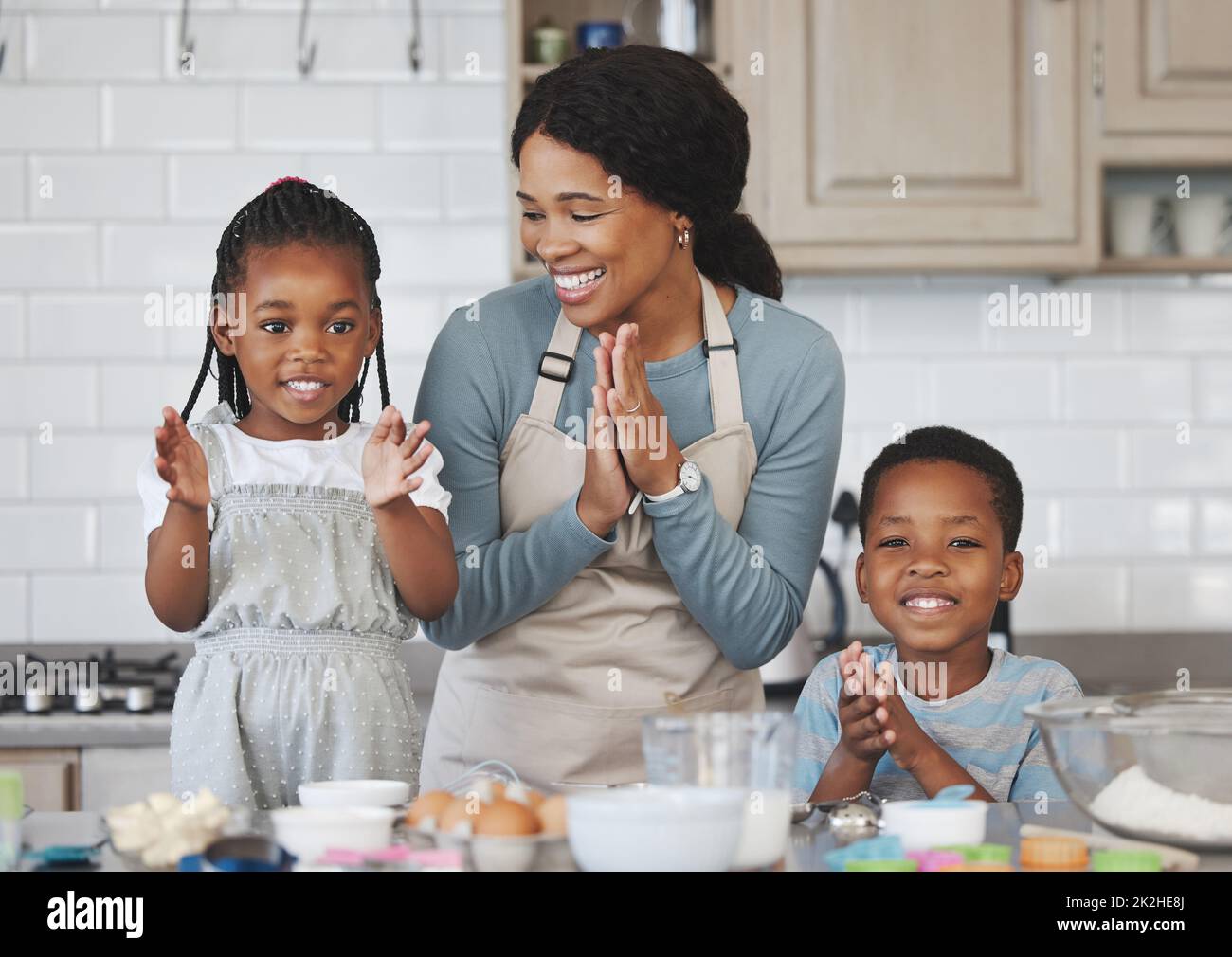 Baking is like washing, the results are equally temporary. Shot of a mother baking with her children at home. Stock Photo