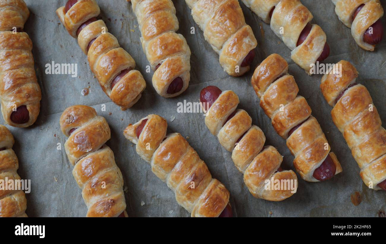 Sausage buns. Soft baked bun (dough )stuffed with sausage for fast food breakfast or coffee break. Sausage  roll, (hot dog). Stock Photo