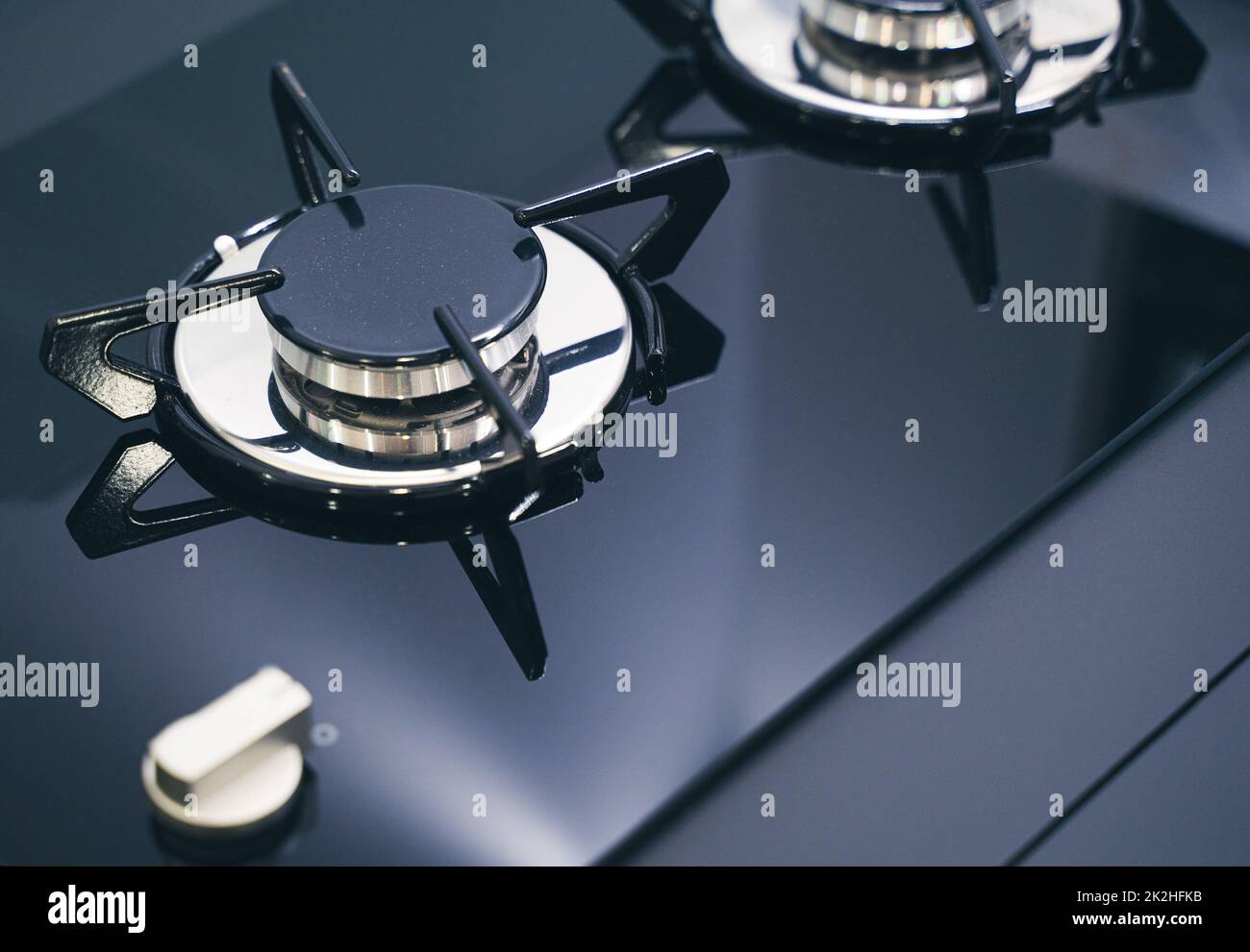 closeup of expensive black gas stove with glass and metal finish Stock Photo