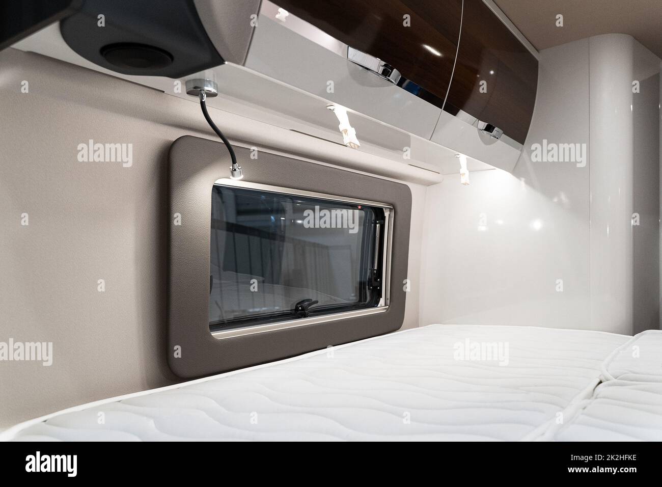 bed near window in luxury RV camper trailer Stock Photo