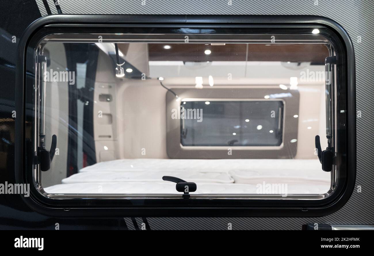 outside view of camp caravan window with bedroom inside Stock Photo