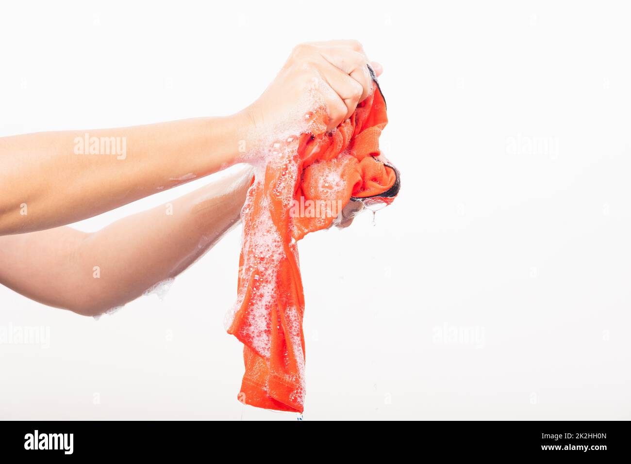 Woman use hands washing color clothes with detergent have soapy bubble water Stock Photo