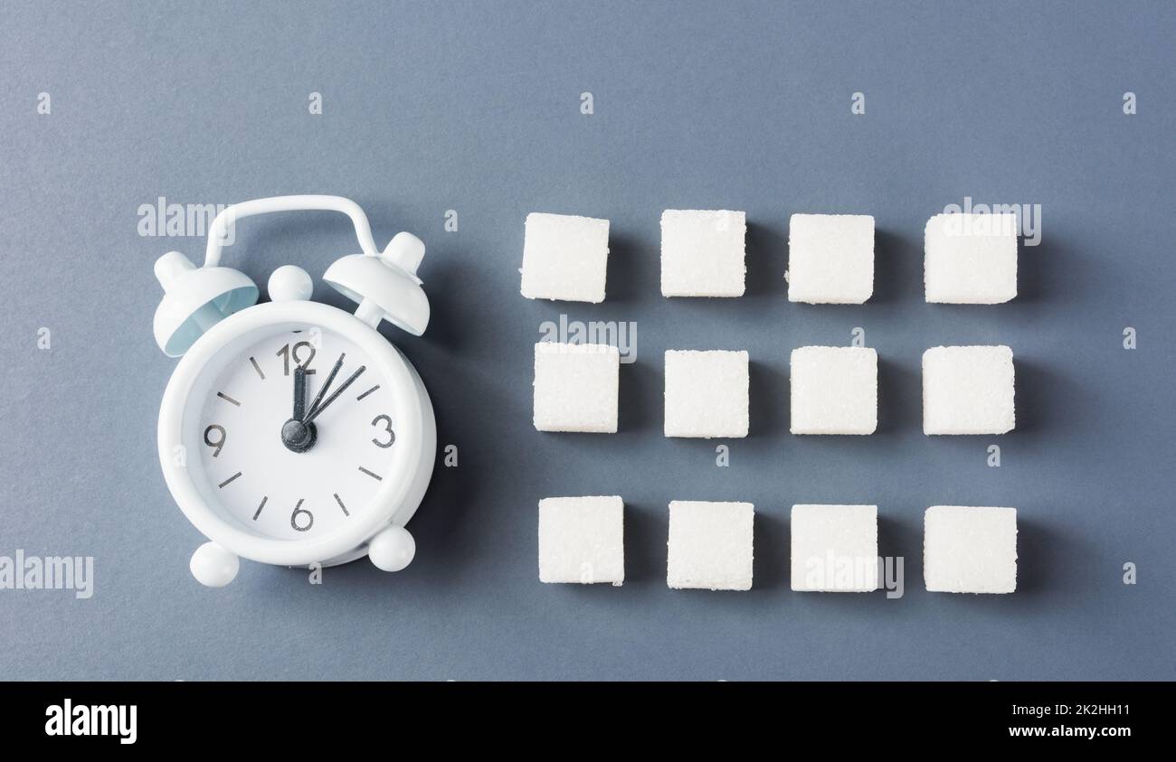 sugar cube sweet food ingredient geometry pattern and alarm clock Stock Photo